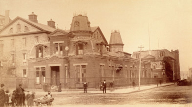 Bellevue Hospital, New York City: a street corner with hospital buildings and people, 1885-1898. Creator: Unknown.