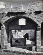 Partly ruined buildings in Ostia identified as a tavern or hot-food shop (thermopolium)..., 1920-9. Creator: Domenico Anderson.