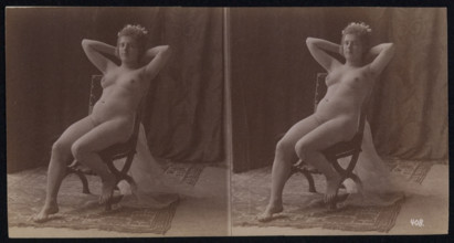 A young woman posing naked but for a long veil, leaning back in a chair, in a photographic..., c1900 Creator: Unknown.