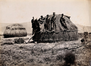 Africa: a group of African people standing on a kraal hut, between 1800 and 1899. Creator: Unknown.