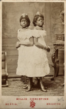 The Millie-Christine sisters, conjoined twins, standing, 1874. Creator: Bertin.