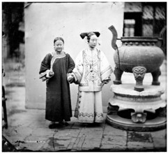China: a Manchu woman with her maid standing beside a bronze burner, Beijing, 1869. Creator: John Thomson.