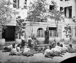 Prince Chulalongkorn of Siam [Thailand] (seated, centre), with Prince Bhanugrangsi Savan..., 1866. Creator: John Thomson.