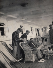 Members of the British Association playing at phrenology on board a ship on its way to..., 1905. Creator: James Thomson Bottomley.