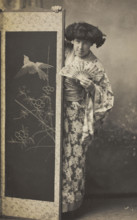 A man wearing a kimono posing from behind a screen, 1906. Creator: Unknown.