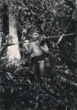 Sarawak: a Kenyah hunter with blowpipe and dead animal, c1900. Creator: Unknown.