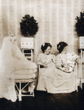 Josefa Blazek and Rosalia Blazek (Rosa Blazek), female conjoined twins, seated, holding...c1910. Creator: Unknown.