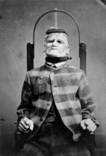 Wakefield Prison, Yorkshire: an elderly man, struggling against the restraint-chair in..., c1869. Creator: Unknown.