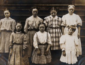 New York State Institute: a group of girls with Down's syndrome, standing on some steps, 1902. Creator: Unknown.
