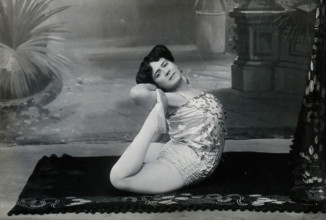 A Bulgarian female acrobat performing contortions in a photographic studio, between 1890 and 1910. Creator: Unknown.