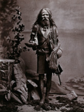 An Indian man wearing many beads, and carrying a begging bowl and an umbrella, in a..., c1900. Creator: Unknown.