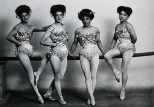 Four young woman acrobats (?), posing on a bar in a photographic studio, between 1899 and 1908. Creator: Unknown.