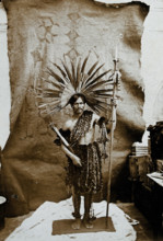 A man of an Amazonian tribe, holding a spear and wearing a feathered head-dress, in a..., 1900. Creator: Marc Ferrez.