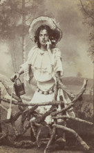 A sailor in drag posed behind a wooden fence, 1906. Creator: Unknown.