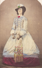 A man in drag wearing an elaborate dress and feathered hat, (20th century?). Creator: Unknown.