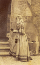 A man in drag posing in historical costume, (between 1890 and 1899?). Creator: Unknown.