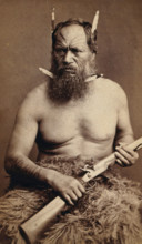 A Maori man with a tattoed face, holding a rifle, c1870s. Creator: James Bragge.