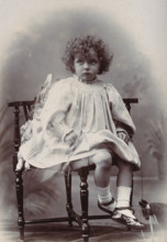 Nora Schuster aged 3, seated, facing forwards, c1895. Creator: Mrs Fred Wilkinson.