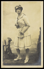 An actor, in drag, performing English theatre at a prisoner of war camp in Cottbus, [1910-1919?]. Creator: Unknown.