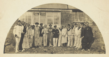 Sailors with men in drag outside a building, [between 1910 and 1919?]. Creator: Unknown.