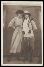 Two men, both in drag, pose wearing hats and make-up, c1918. Creator: Unknown.