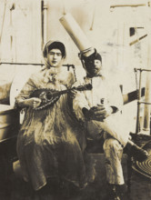 Two sailors (?) on board ship: one in drag is playing a guitar, 1907. Creator: Unknown.