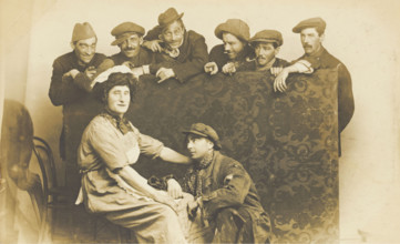 Actors gathered around a man in drag, between 1910 and 1919. Creator: Unknown.