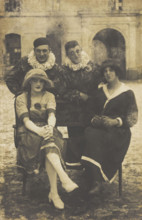Members of 'The Stars' concert party, two soldiers in drag and two as pierrots, pose around..., 1919 Creator: Unknown.