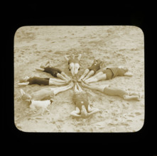 A group of female swimmers lying in a circle on the beach probably at Clacton-on-Sea..., 1920s.  Creator: Norman Kingsley Harrison.