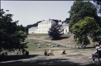 A view from the south-east looking towards Kenwood House, with people relaxing on the lawn..., 1984. Creator: Dorothy Chapman.