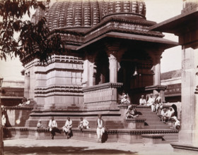 Indian men sitting on steps outside a domed building in Bombay during an outbreak of plague, 1896/7. Creator: Unknown.