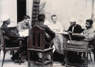 A group of men taking notes at a table, during a plague epidemic in Mandalay, 1906. Creator: Unknown.