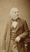 An unidentified man leaning on a cabinet, c1880s. Creator: Frederick Mulnier.