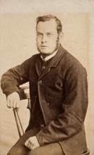 A young man, seated, with an intense expression in his eyes, c1890s. Creator: John Davis.