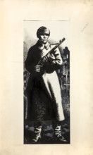 Russian infantryman, standing amidst ruins of town, between 1939 and 1946. Creators: Central Office of Information, Unknown.