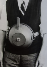 Cecil Vandepeer Clarke wearing an early version of the limpet mine on a keeper plate, c1939.  Creator: British Government.