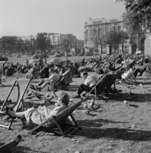People relaxing on deck chairs amongst the pigeons in Hyde Park, London, 1960-1970. Creator: John Gay.