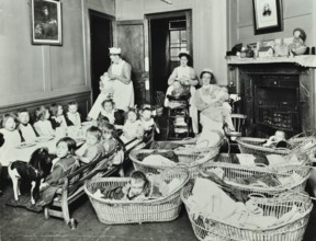 30 Albury Street; Nursey at dinner time, Children in Baskets, 1911. Creator: Unknown.