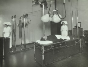 A patient undergoes a medical procedure, c1950s. Creator: Unknown.