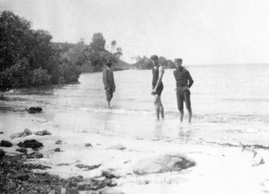 Men in swimming costumes at the water's edge, possibly at the mouth of the Tweed River, 1910. Creator: Robert Augustus Henry L'Estrange.