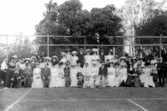 Possibly City Electric Light company employees and their families on a tennis court, 1903. Creator: Robert Augustus Henry L'Estrange.