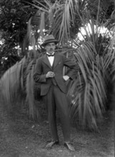 Photos and life story of John Henderson L'Estrange (1864-1913) standing and William Manderville Elli Creator: Robert Augustus Henry L'Estrange.