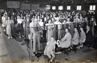 Camouflage net making, Kelvin Grove Drill Hall (now Z 10), Brisbane, 1941. Creator: Isabel Bain.