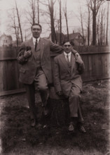 Untitled (two men holding small dog; one sitting on a stump, Fisher St., backyard), c1915. Creator: Wendell Hotter.