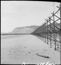View looking south along the beach at Shanklin, showing Admiralty scaffolding, Isle Of Wight, 1945. Creator: George R Long.