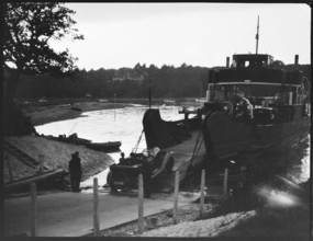 Car driving off the slipway on to the Isle of Wight Ferry at Fishbourne, Isle Of Wight, 1925-35. Creator: George R Long.