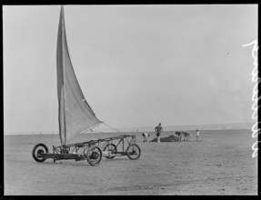 A sand yacht on West Wittering Beach with people digging in the sand, Chichester, West Sussex, 1930s Creator: George R Long.
