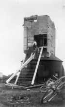 Three men standing on the remains of Golden Cross Windmill, Chiddingly, East Sussex, 1935.  Creator: HES Simmons.