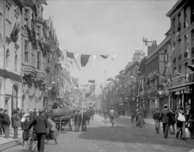 Cornmarket Street decorated with flags and banners for a royal visit, Oxford, Oxfordshire, 1897.  Creator: Henry Taunt.