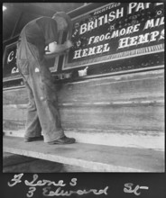 Barge painter Frank Jones, of 3 Edward Street, at work, Leighton Buzzard, Bedfordshire, 1910-60. Creator: George R Long.